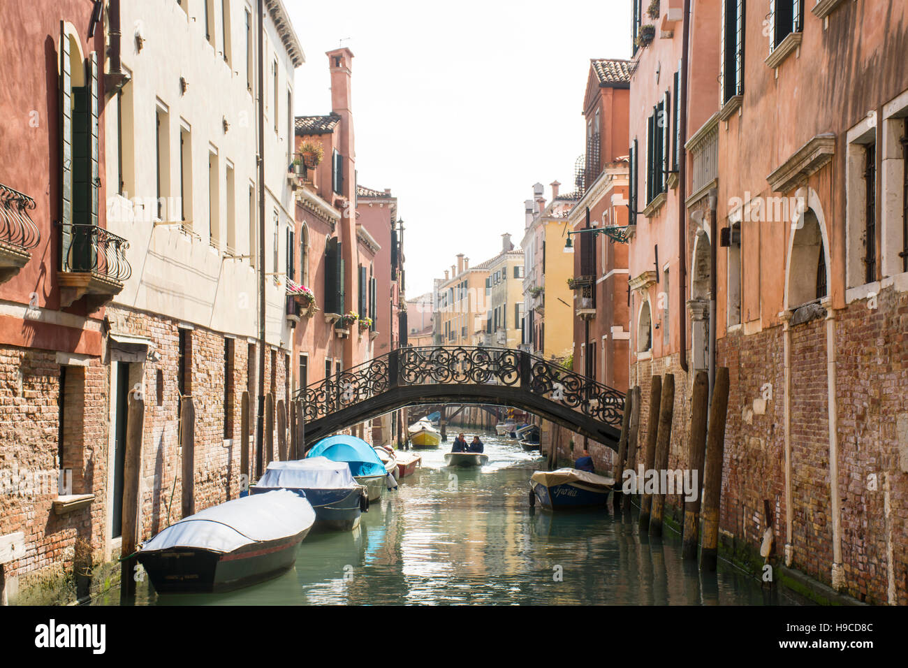 Boats in a narrow canal in Venice, Italy Stock Photo