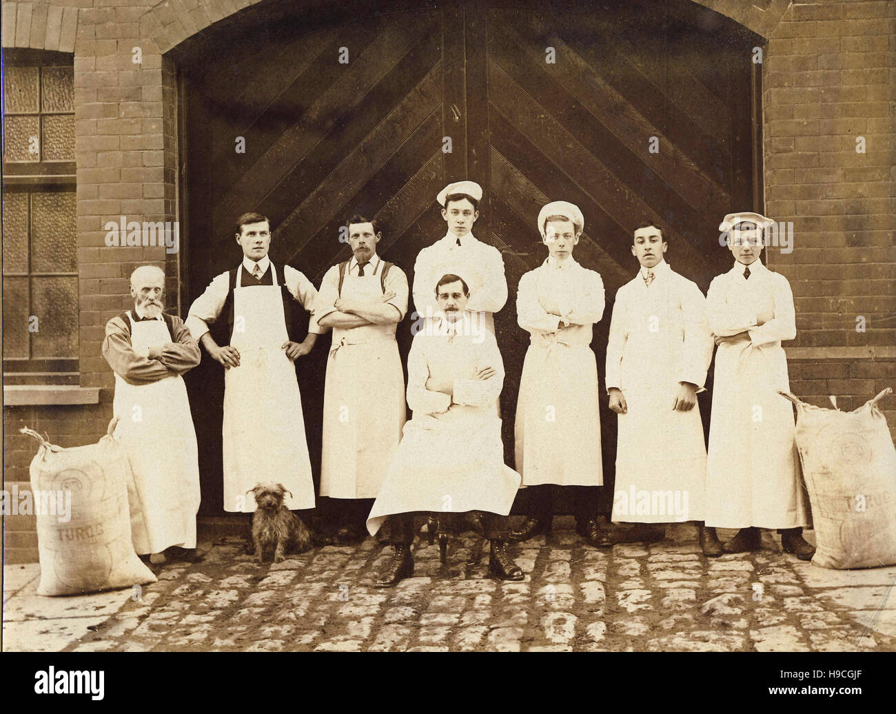 Historic archive image of flour mill or bakery workers with bags of