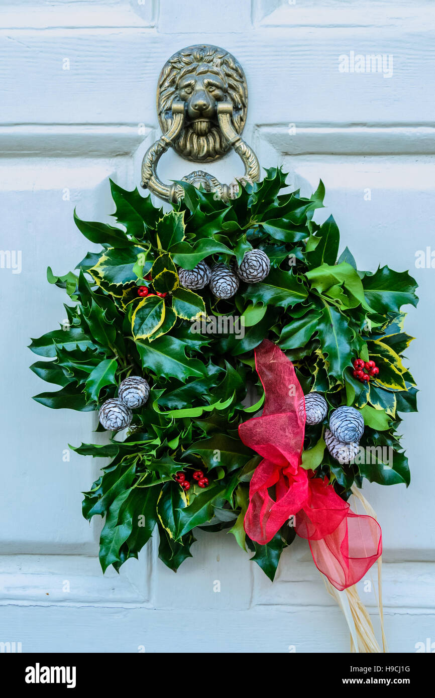 Christmas holly wreath on front door Stock Photo