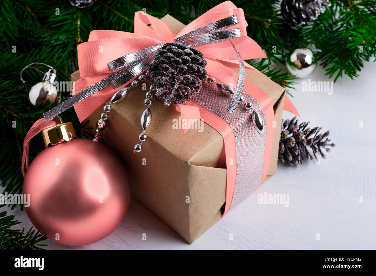 Christmas gift box with pink ribbon and silver beads. Christmas