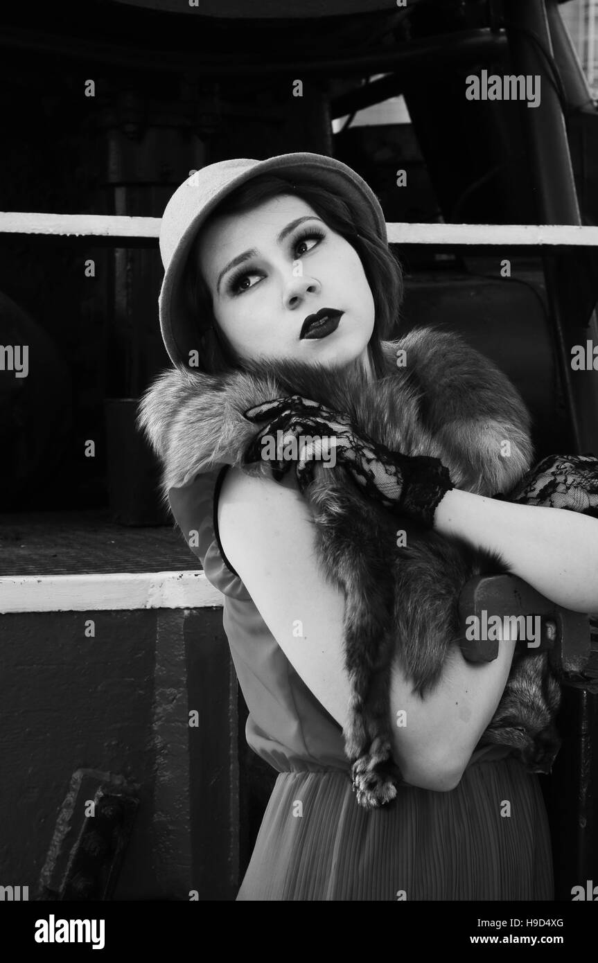 Beautiful fashion woman in retro clothes with on railway