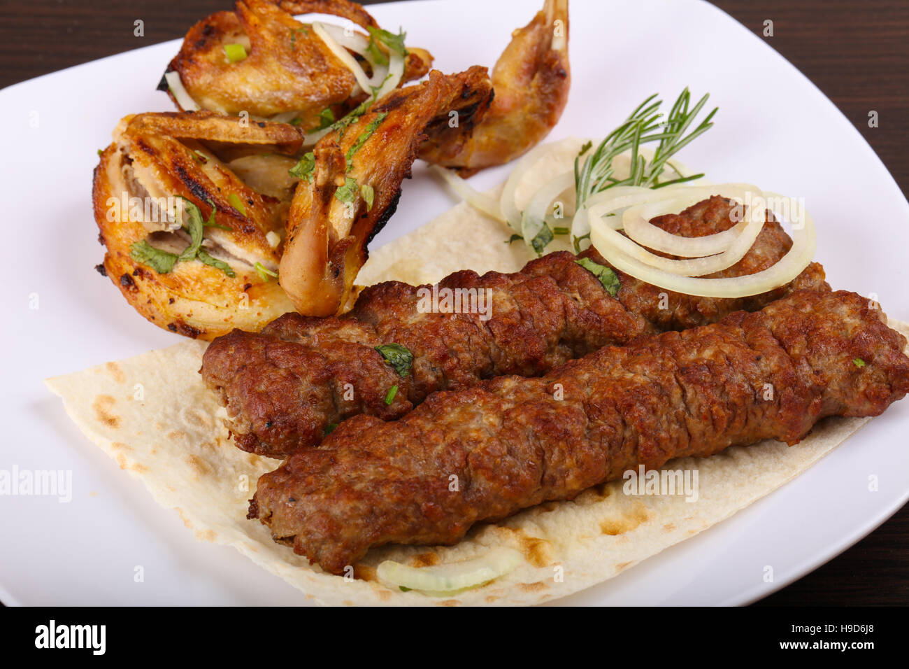 Beef kebab and grilled Quail with onion and parsley Stock Photo Alamy