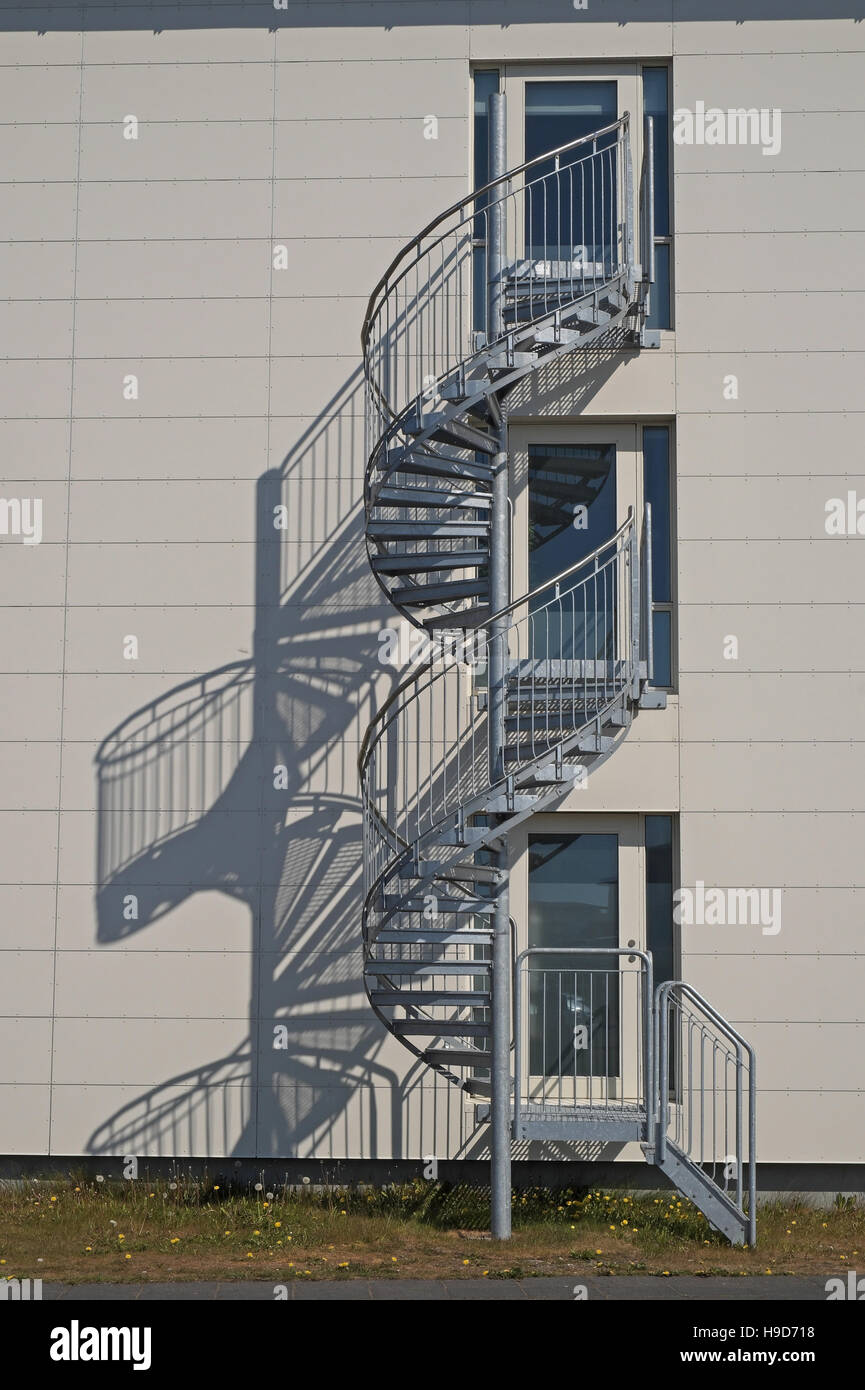 Spiral staircase and its shadow on the wall of a modern building, Hofn, south east Iceland. Stock Photo