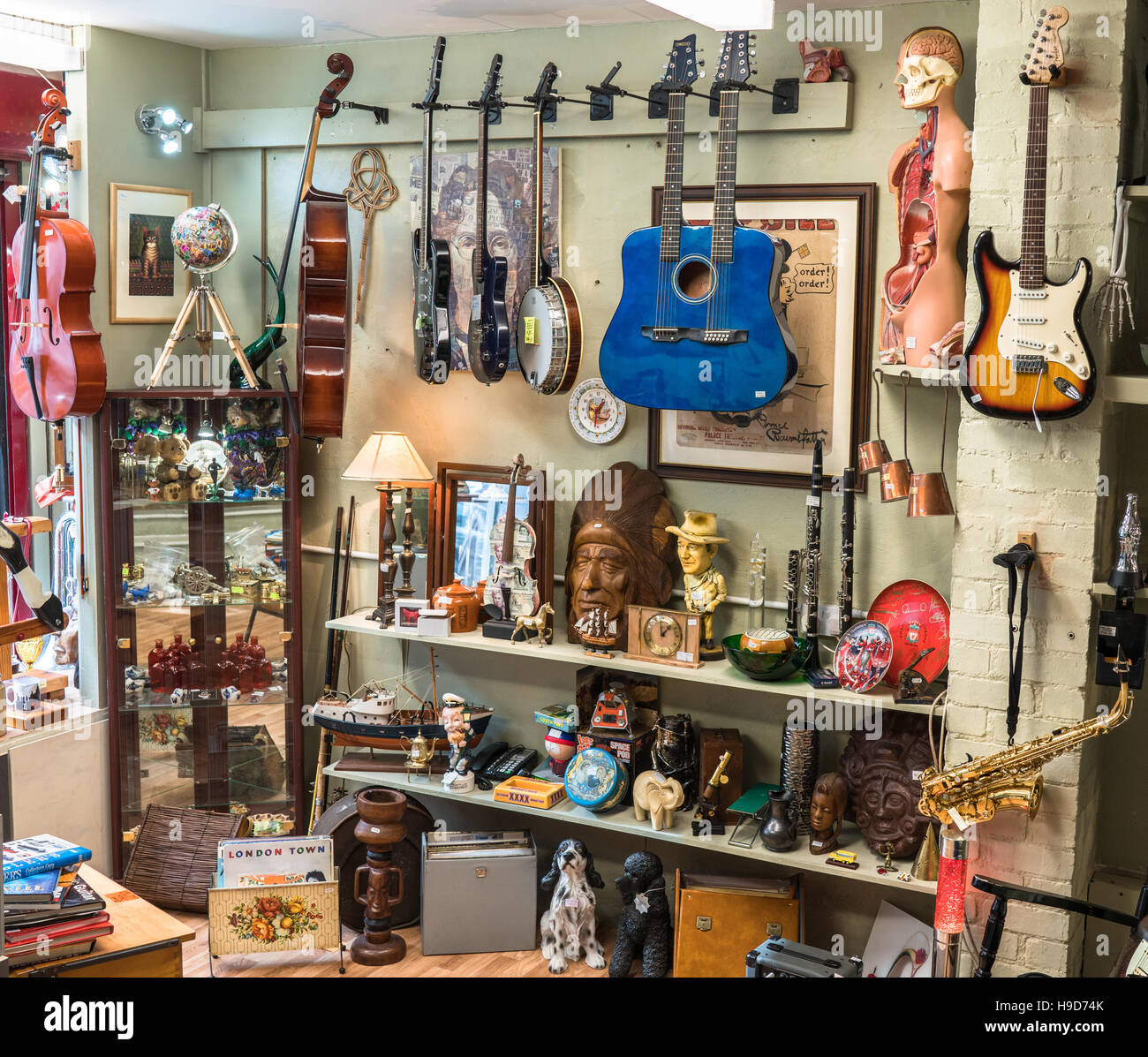 Various musical instruments and collectibles for sale in a second hand shop selling music memorabilia, fashion items and vinyl in Liverpool, Uk. Stock Photo