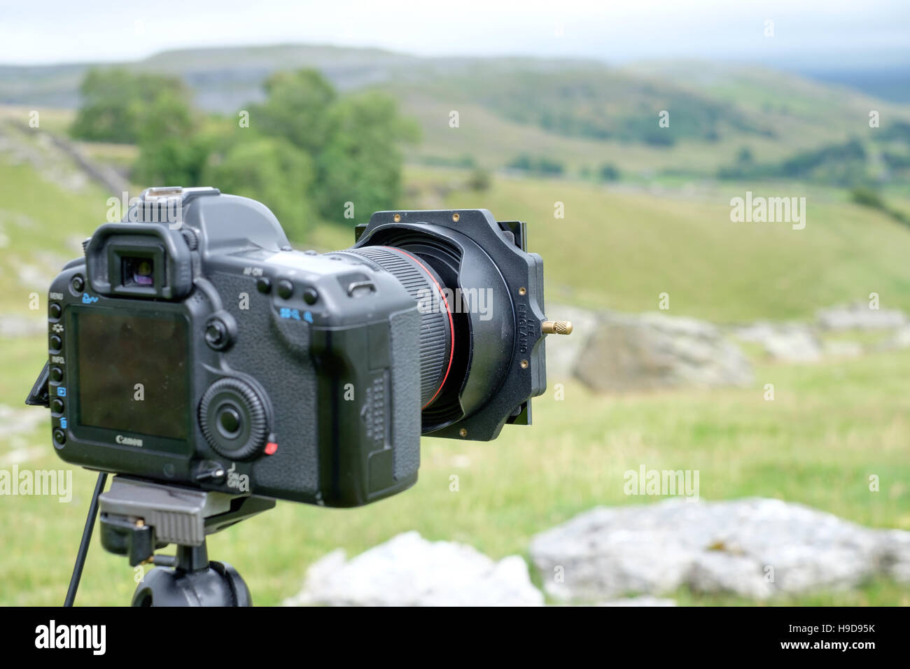 DSLR Camera with filter on tripod taking a landscape image Stock Photo