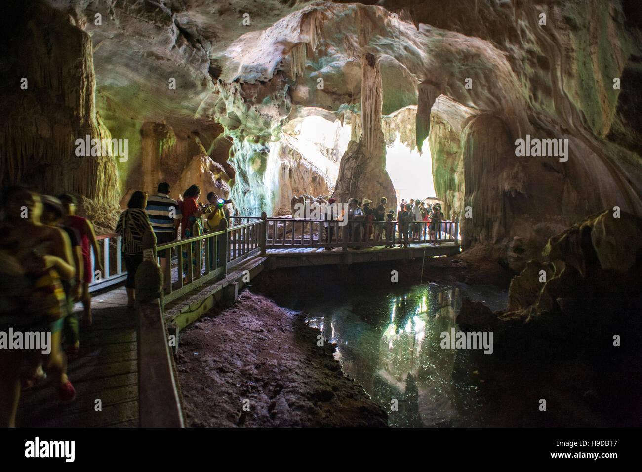 Tourists wander though the Bat Cave at the Kilim Karst Geoforest Park in Langkawi, an island in north West Malaysia. Stock Photo