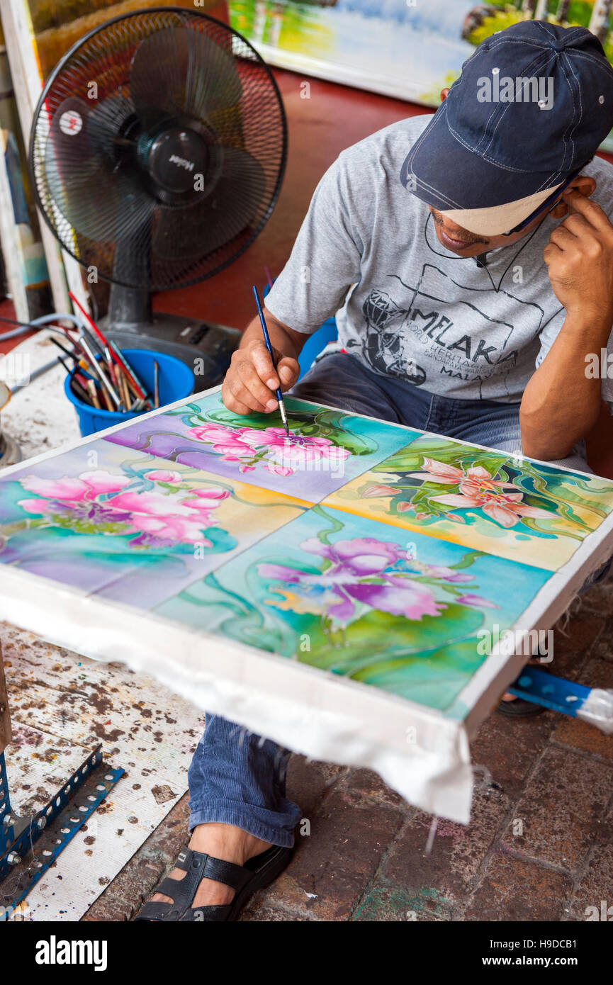 A man painting batik in Malacca, the World Heritage listed town flanking the Straits of Malacca on Peninsula Malaysia. Stock Photo