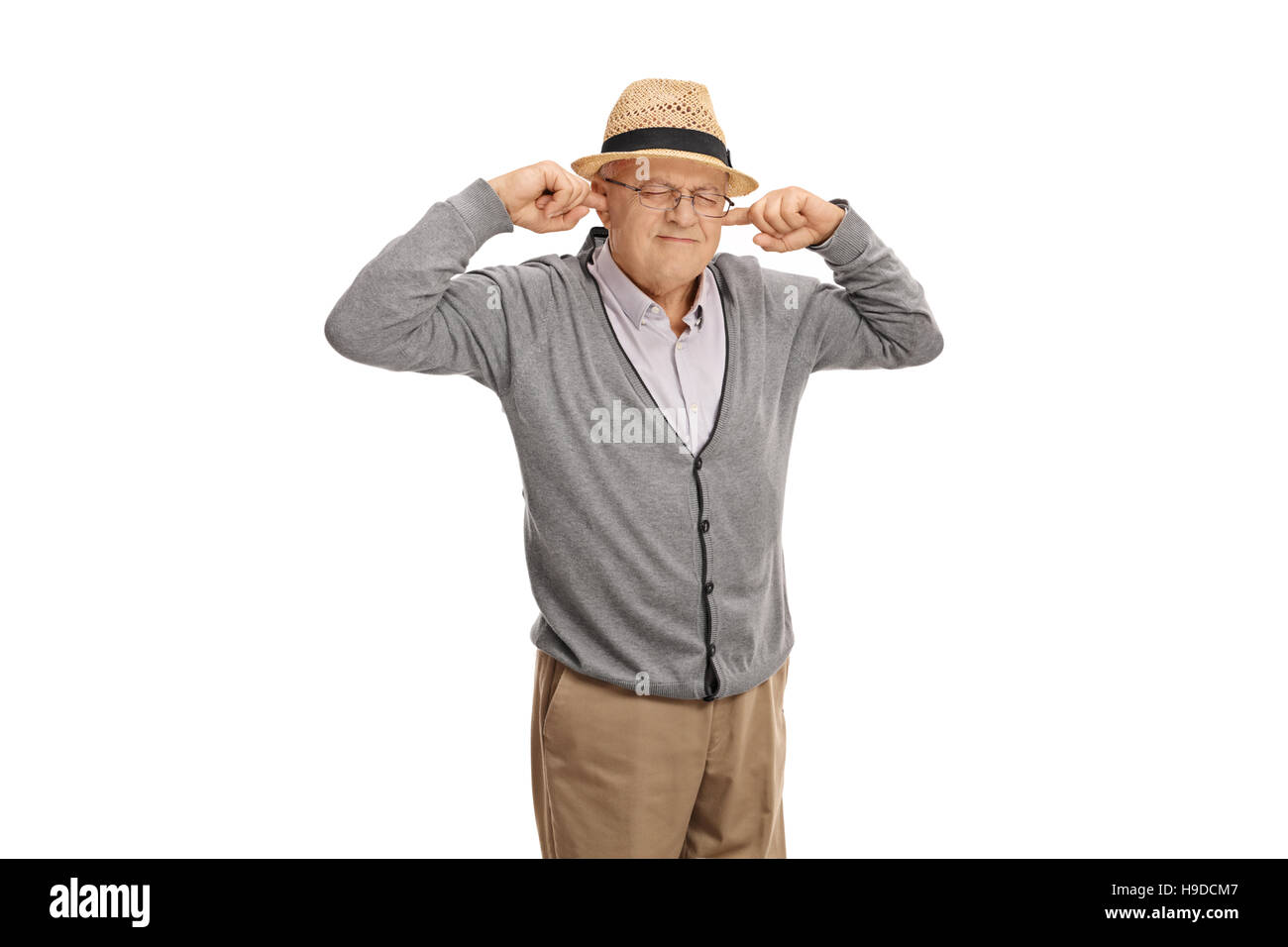 Mature man plugging his ears with his fingers isolated on white background Stock Photo