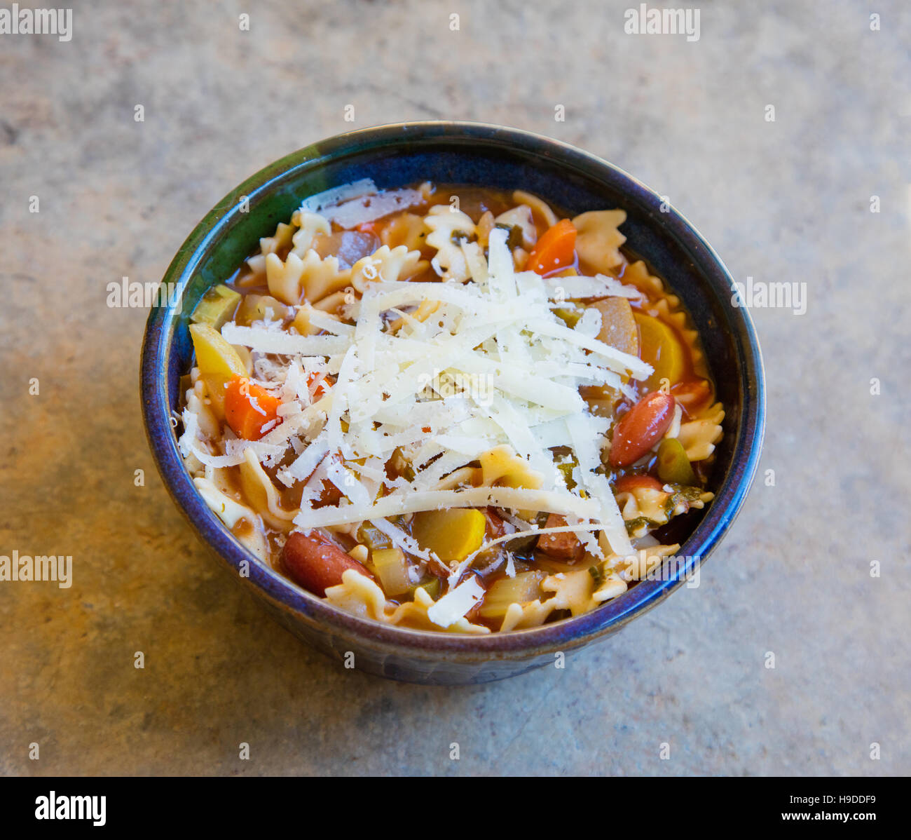 A bowl of minestrone soup with shredded fresh parmesan cheese Stock Photo Alamy