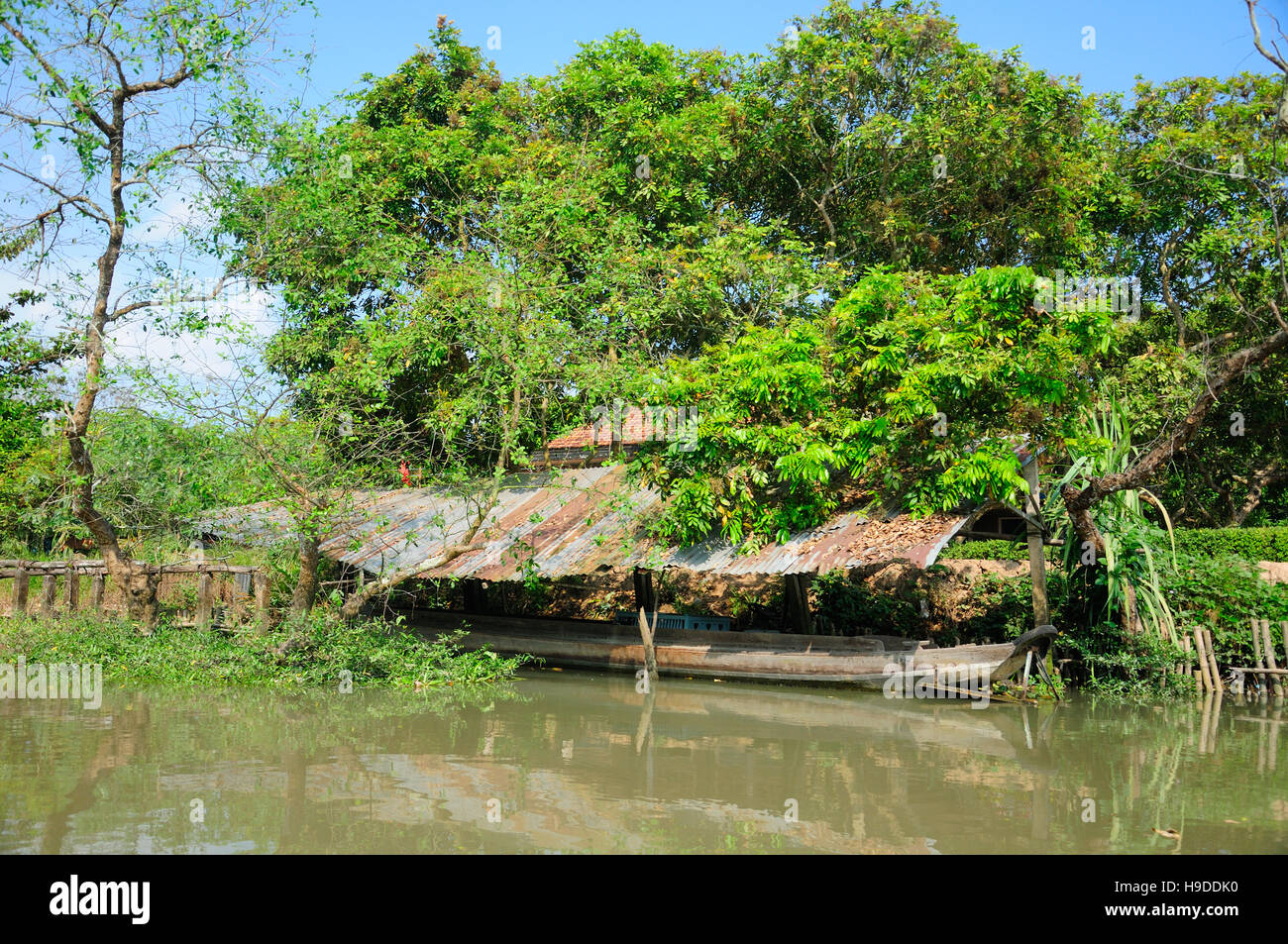 A covered area protecting a boat within the Mekong river delta in Vinh Long area of South Vietnam on a sunny day. Stock Photo