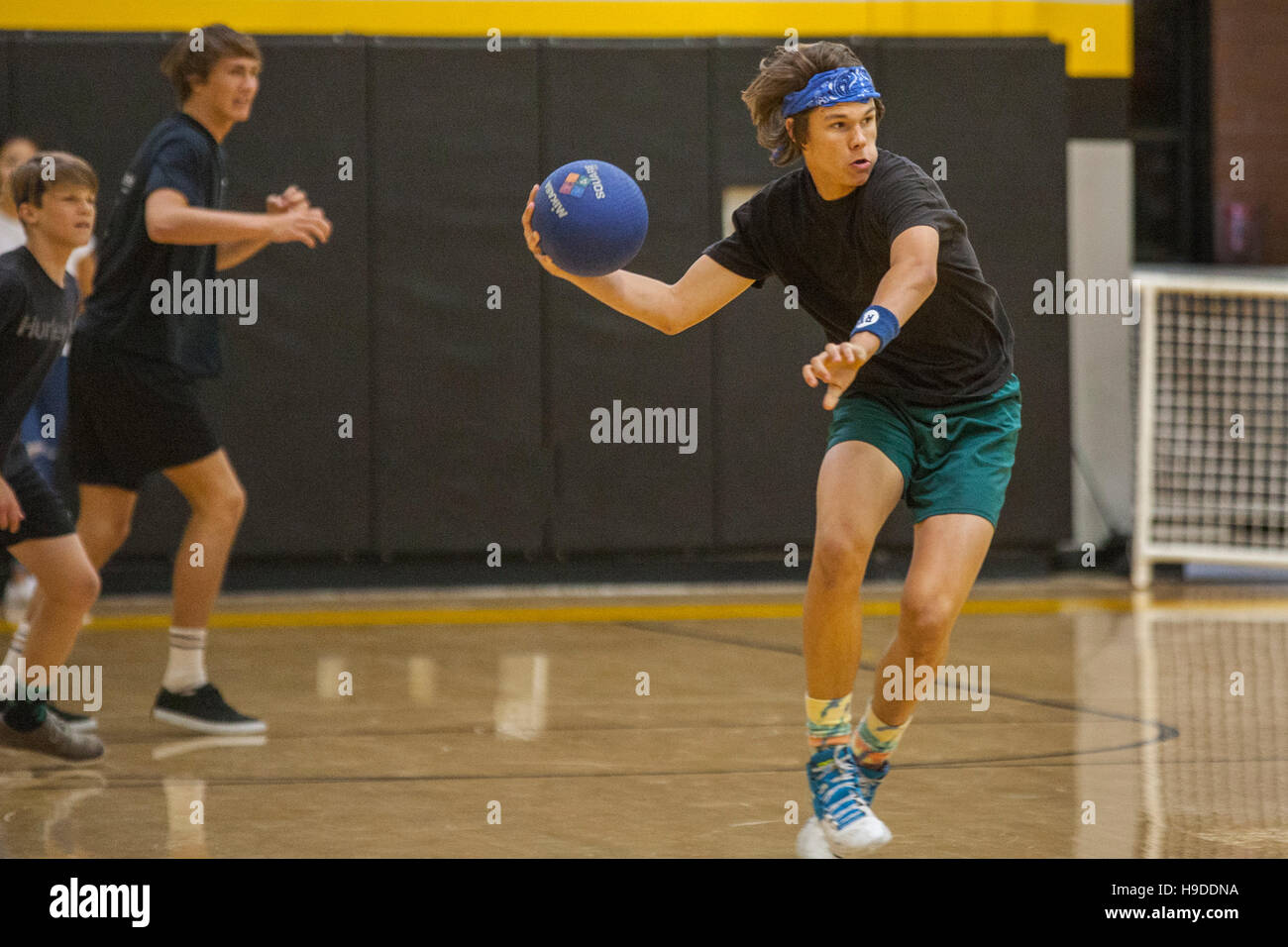 High school athletes in San Clemente, CA, play a dodge ball game in the school gymnasium Stock