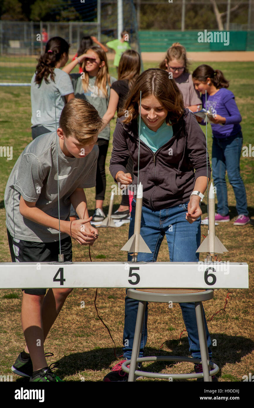 Multiracial Mission Viejo, CA, middle school students prepare to launch black powder rockets as part of their science curriculum. Note numbered launching rails. Stock Photo