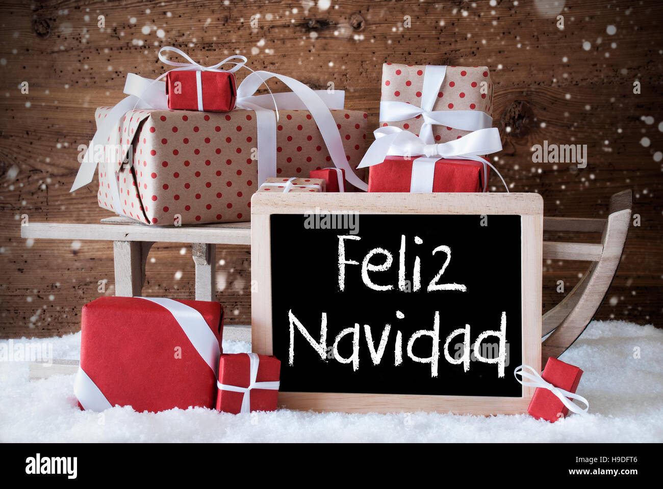 Sleigh With Gifts, Snow, Snowflakes, Feliz Navidad Means Merry Christmas Stock Photo