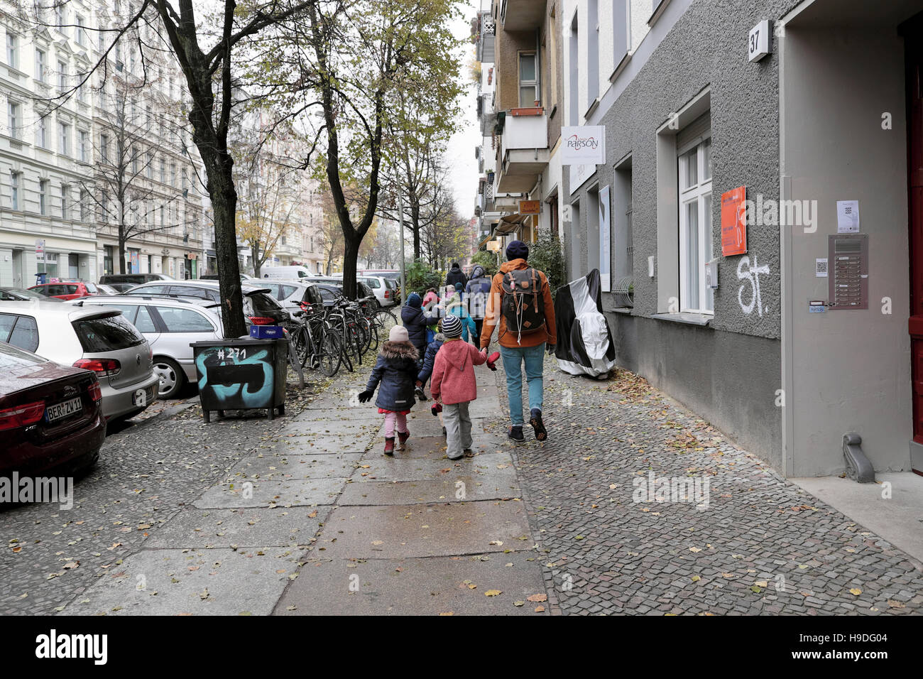 Back view of children walking to a kindergarten nursery in a Prenzlauer