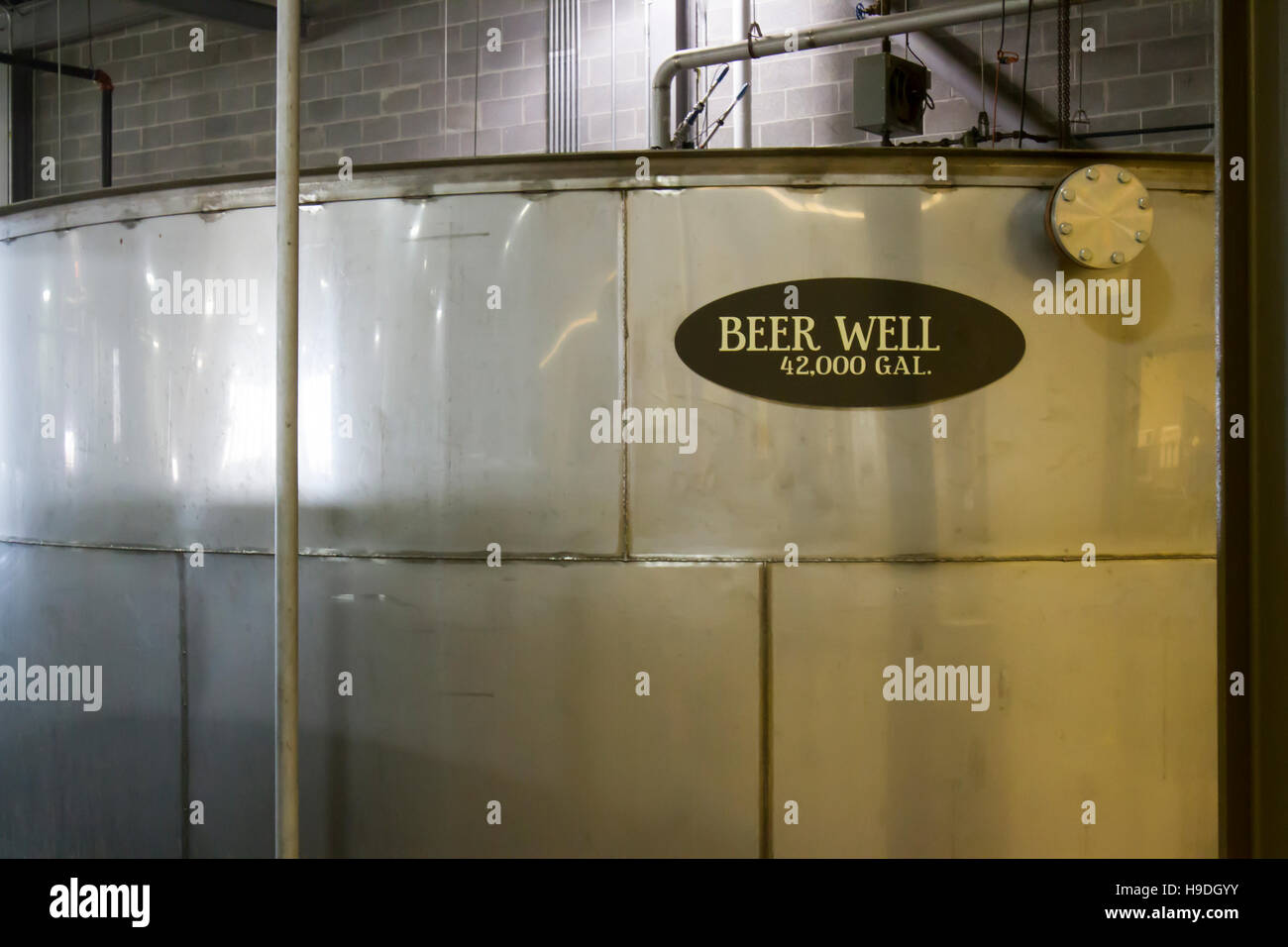 Large metal beer well for distillers beer inside bourbon distillery. Stock Photo