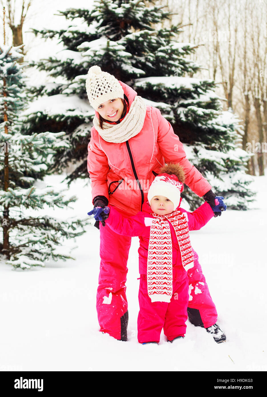 happy young mother and baby in the winter park Stock Photo Alamy