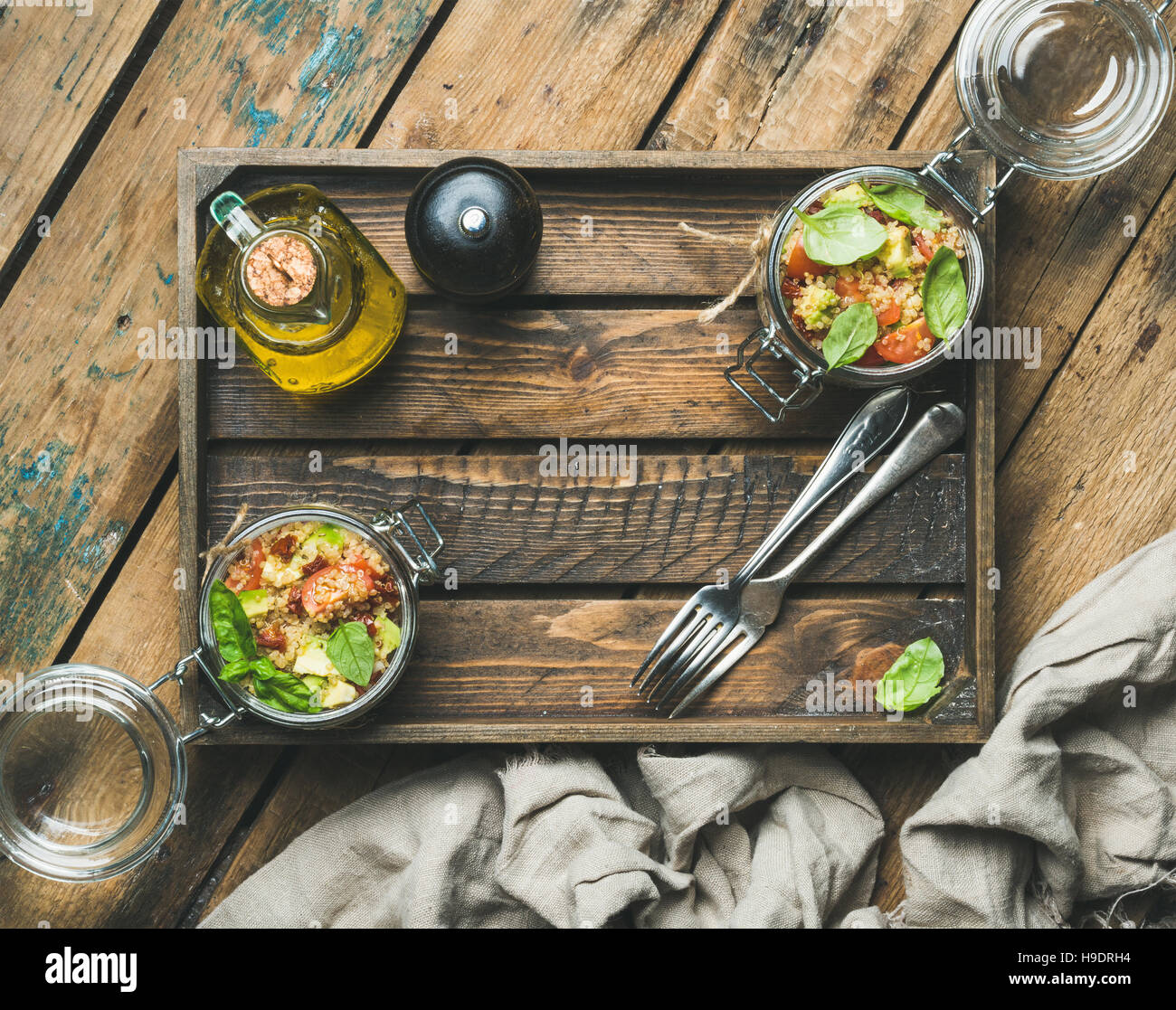 Homemade quinoa salad with cherry-tomatoes, avocado, fresh basil in box Stock Photo