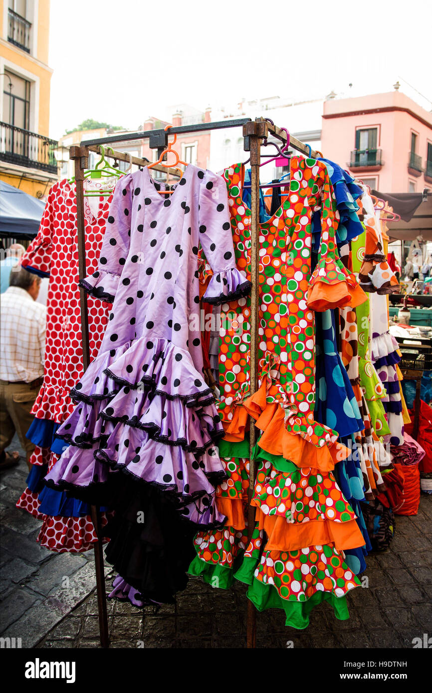 Flamenco dresses for sale on stall at Spanish street market Stock Photo