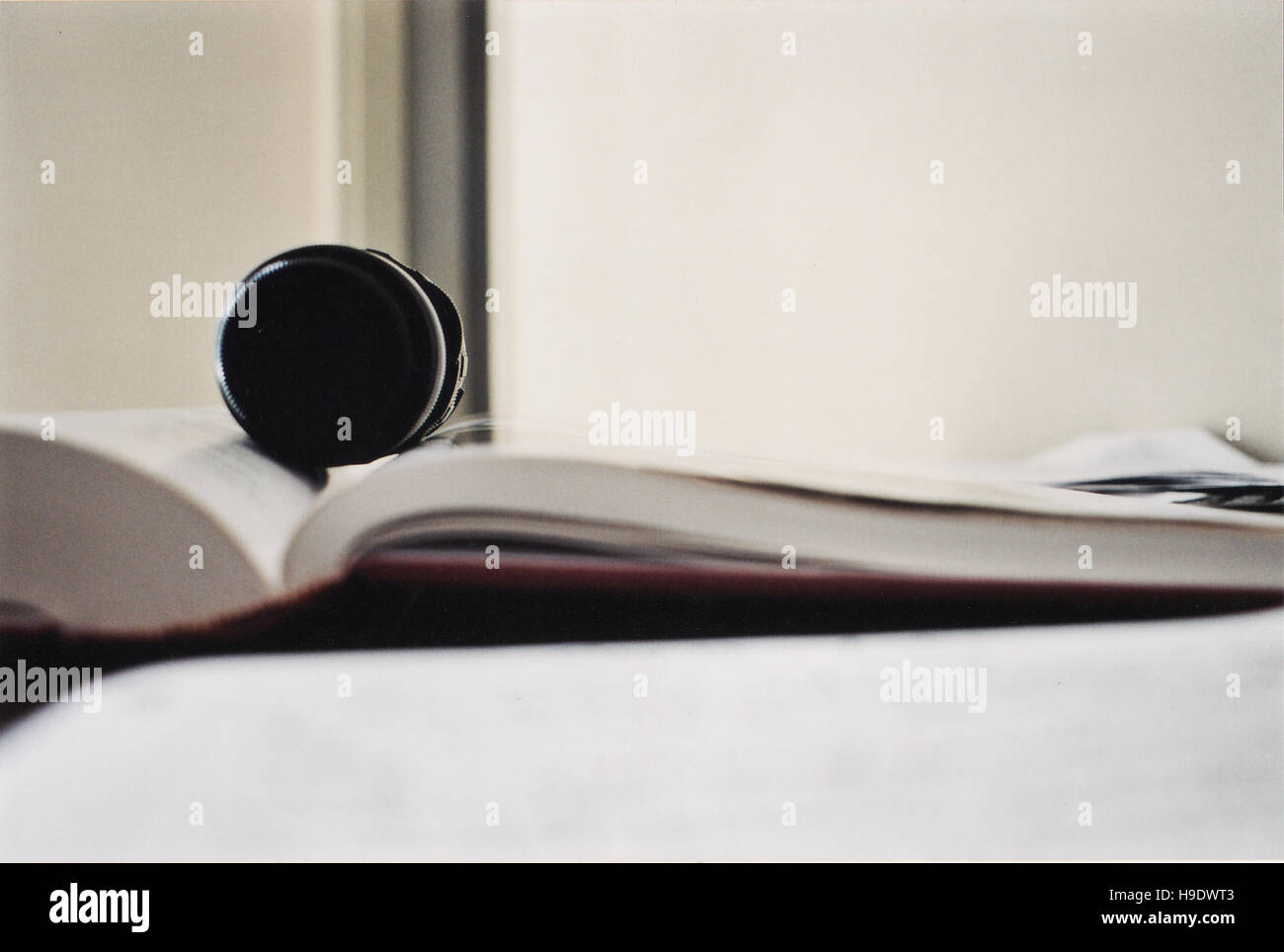 Lens over book Stock Photo