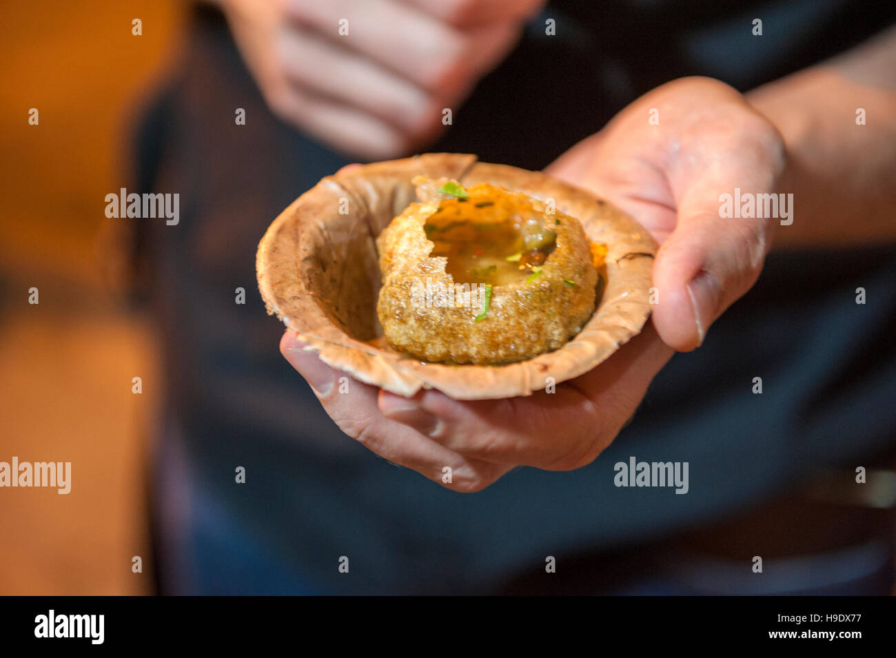 Pani puri, shells of semolina pastry filled with mashed potato, chickpeas, tamarind paste and chaat masala, in Calcutta. Stock Photo
