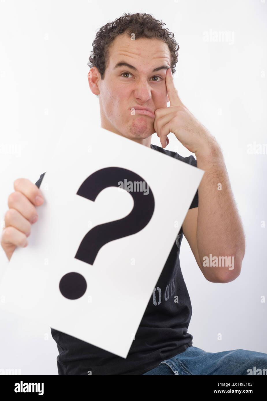 Teenager with a question mark Stock Photo