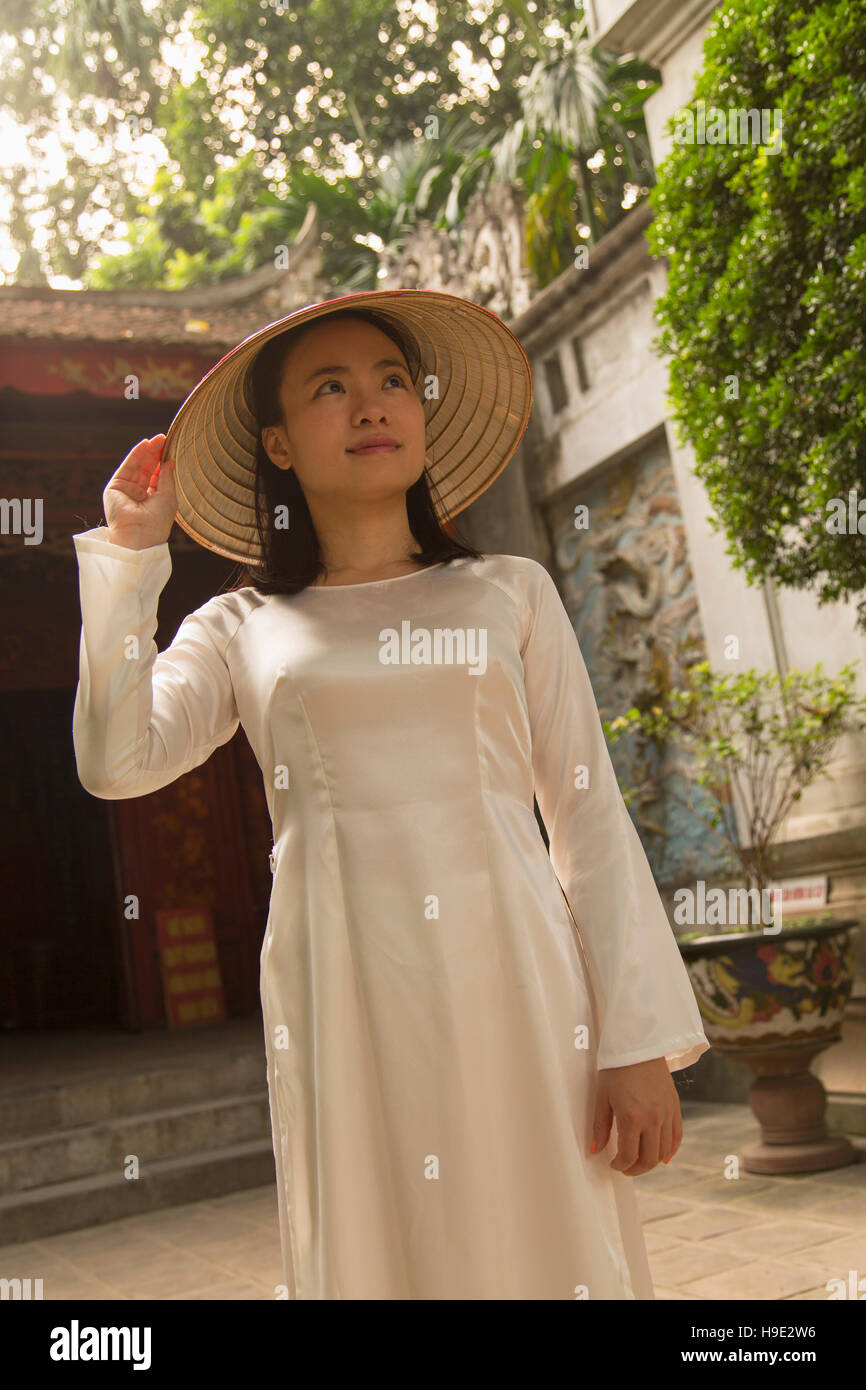 Woman in ao dai dress at Quan Thanh Temple, Hanoi, Vietnam Stock Photo