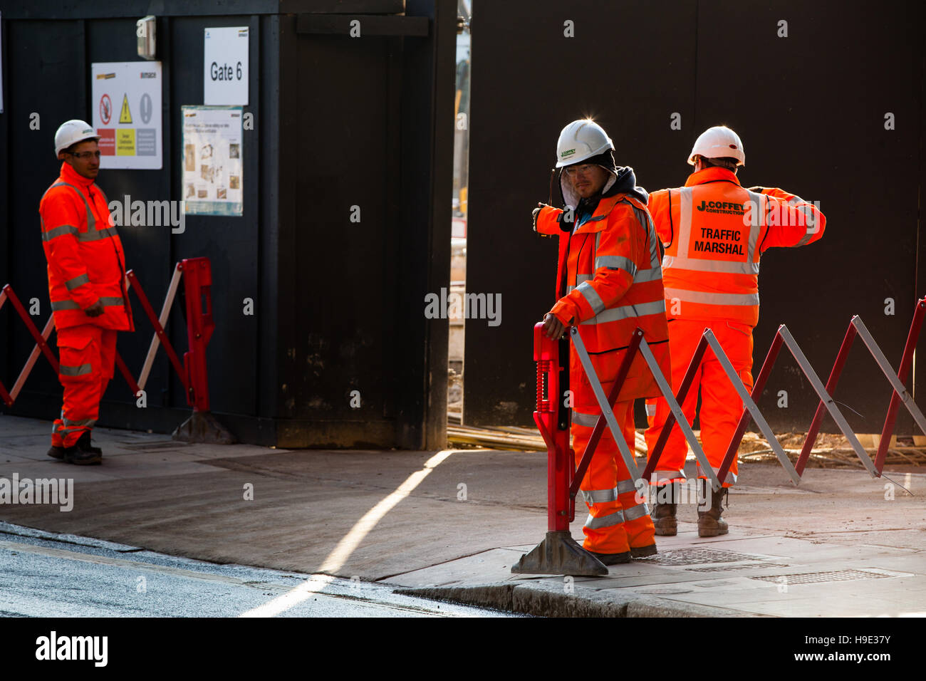 Groundsmen construction site workers in high visibility jackets on a building site, london Stock Photo