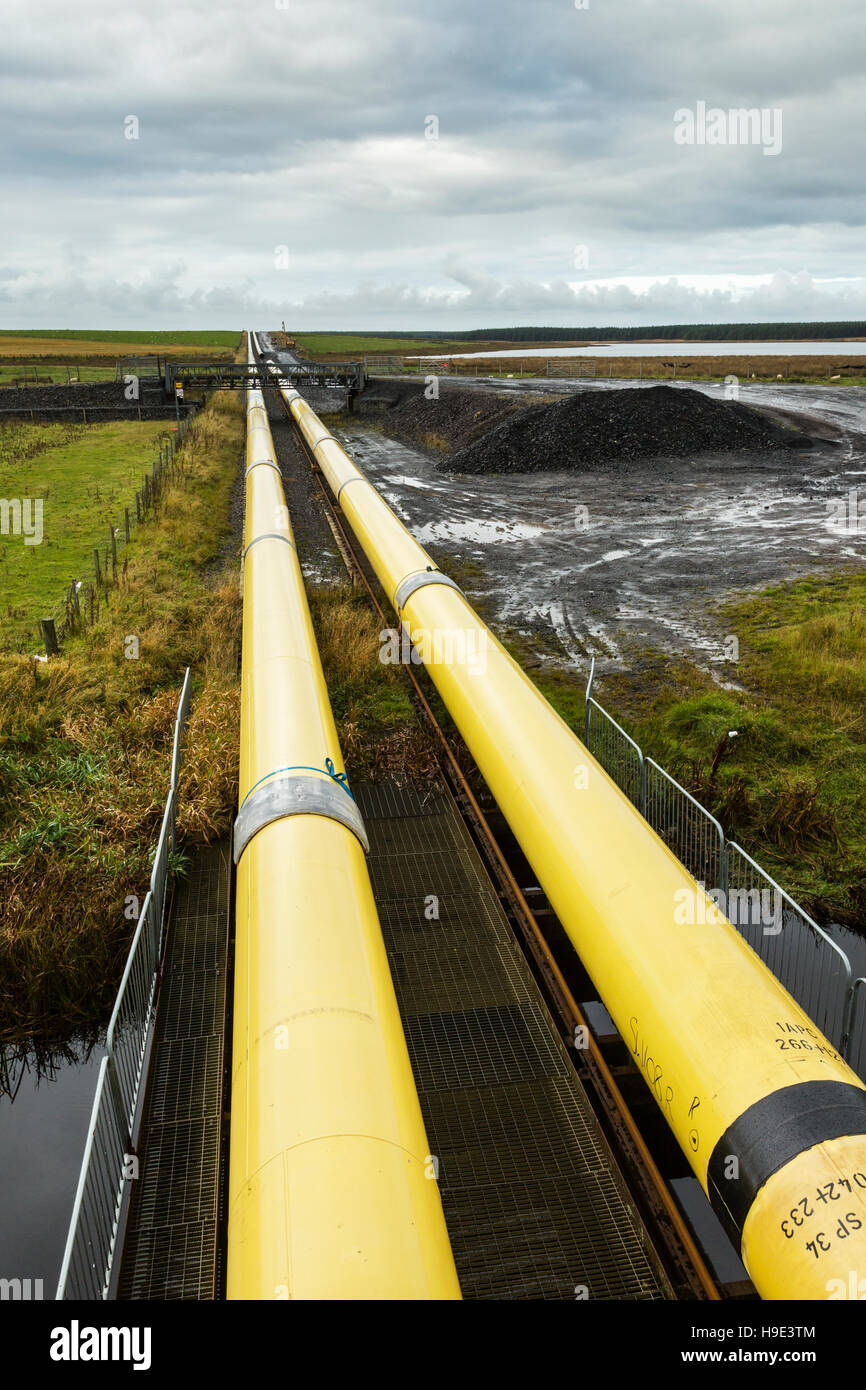 Yellow pipes across Scottish landscape Stock Photo