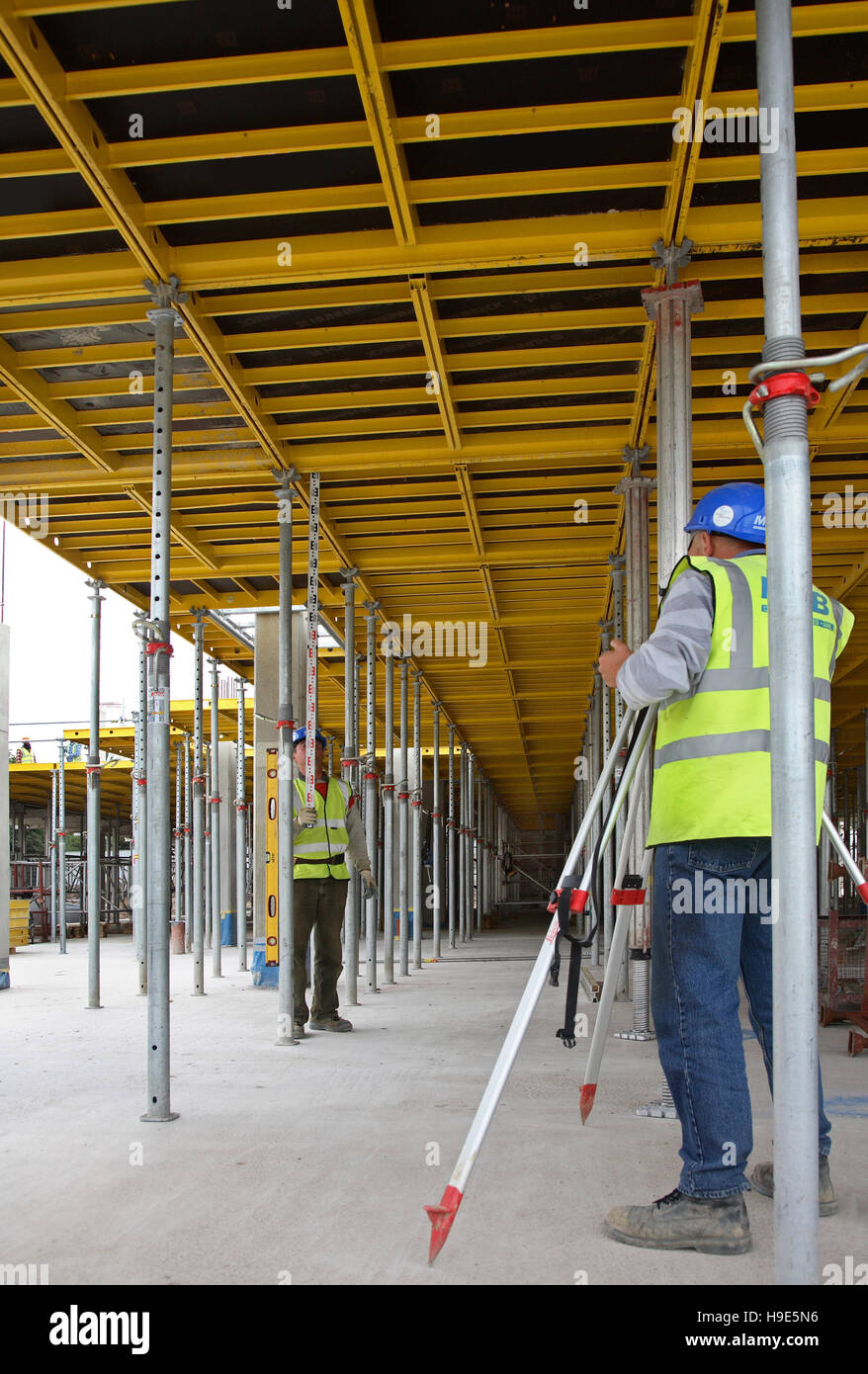 A Surveyor Uses A Level To Check The Positioning Of Formwork Prior
