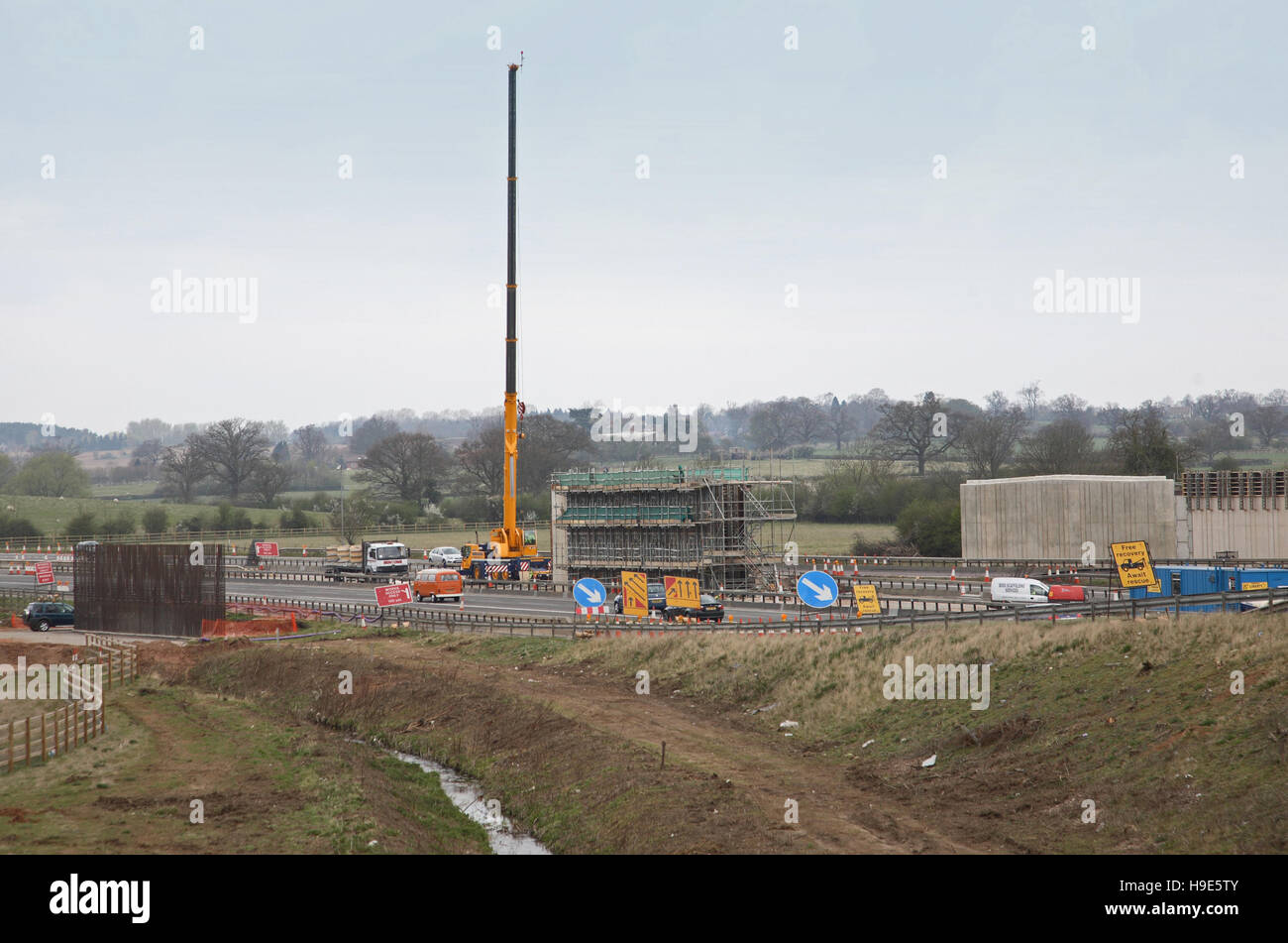 Construction of a new bridge for the A46 to span the M40 motorway, Oxfordshire, UK. Shows formwork for bridge piers and crane Stock Photo