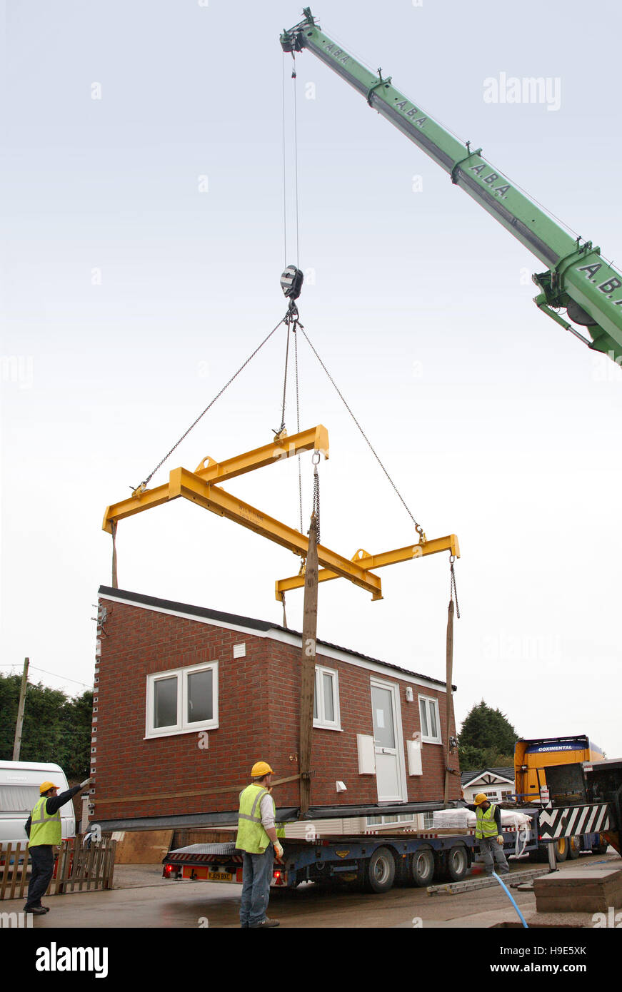 Prefabricated, full-fitted kitchen modules are craned into place on a travelers caravan site in Pathlow, Warwickshire, UK Stock Photo