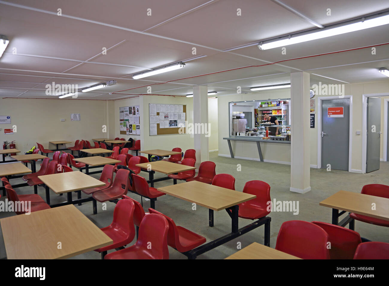 Interior of a temporary workers canteen on a large building site in London, UK. Shows kitchen, servery and seating area Stock Photo