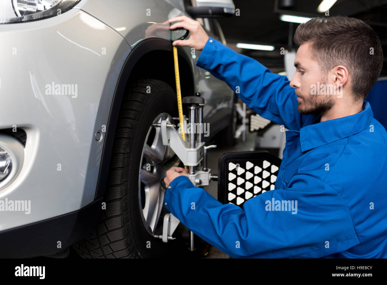 Professional mechanic adjusting automobile wheel alignment Stock Photo Alamy
