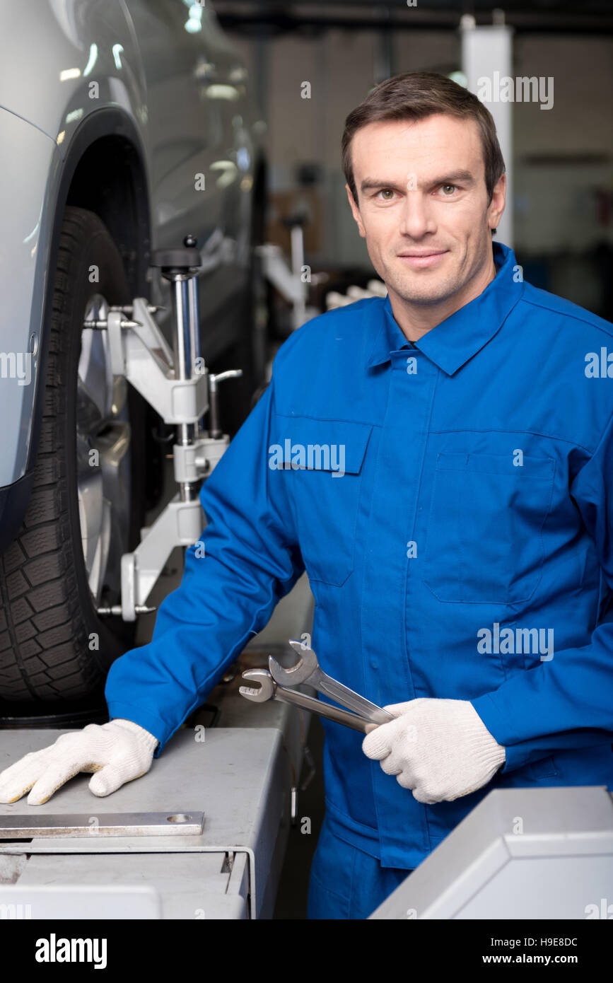 Positive mechanic holding wrench Stock Photo Alamy