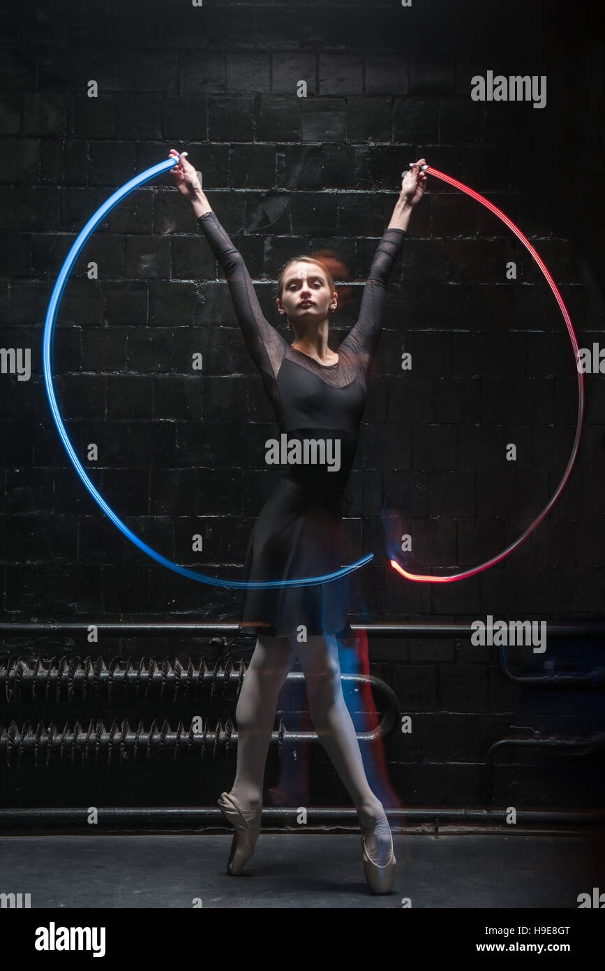 Charismatic ballet dancer dancing with a colorful gymnastic ribbon