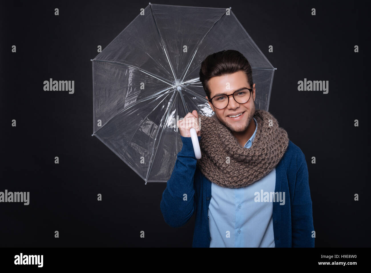 Cheerful smiling man holdign umbrella Stock Photo - Alamy