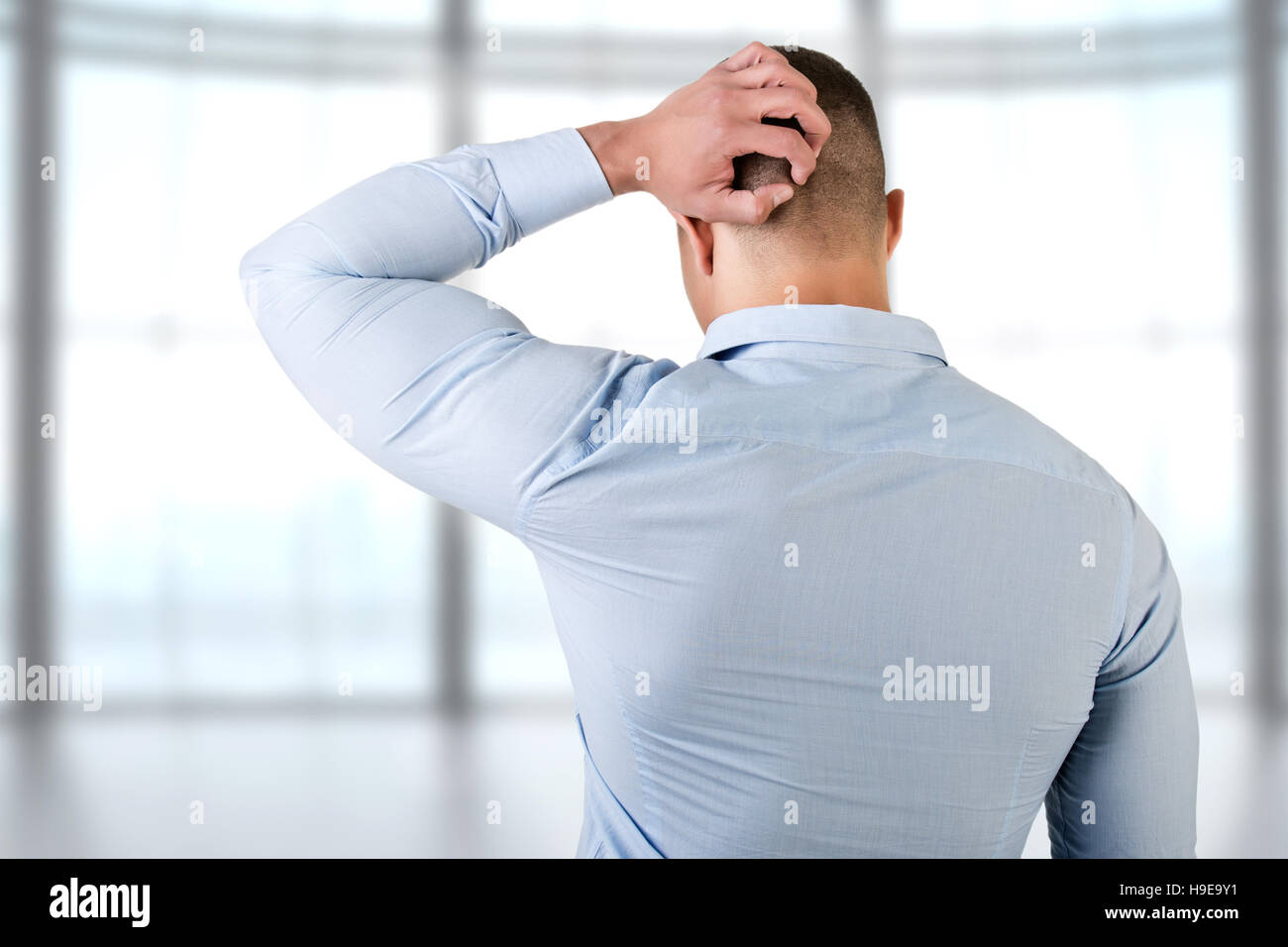 Man holding is head in frustration, isolated in white Stock Photo