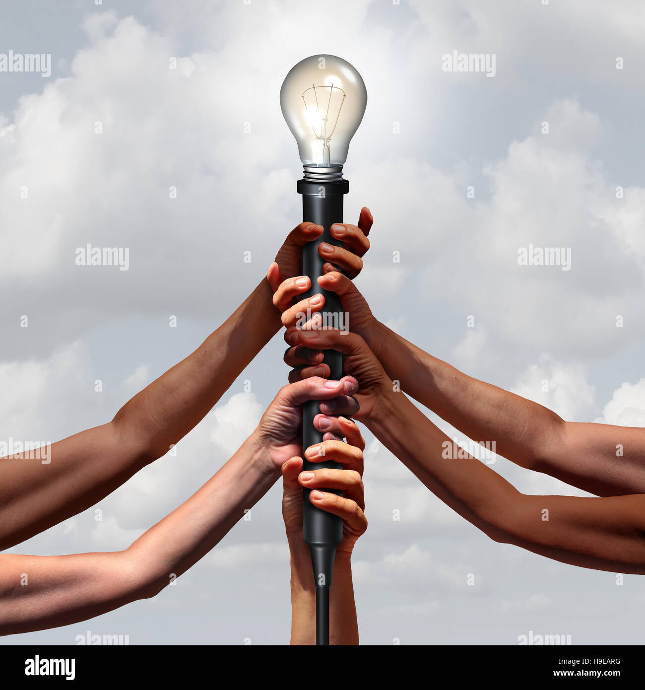 Idea team group as diverse people holding an electric light socket with an illuminated lightbulb as a connected community insight or social thinking c Stock Photo
