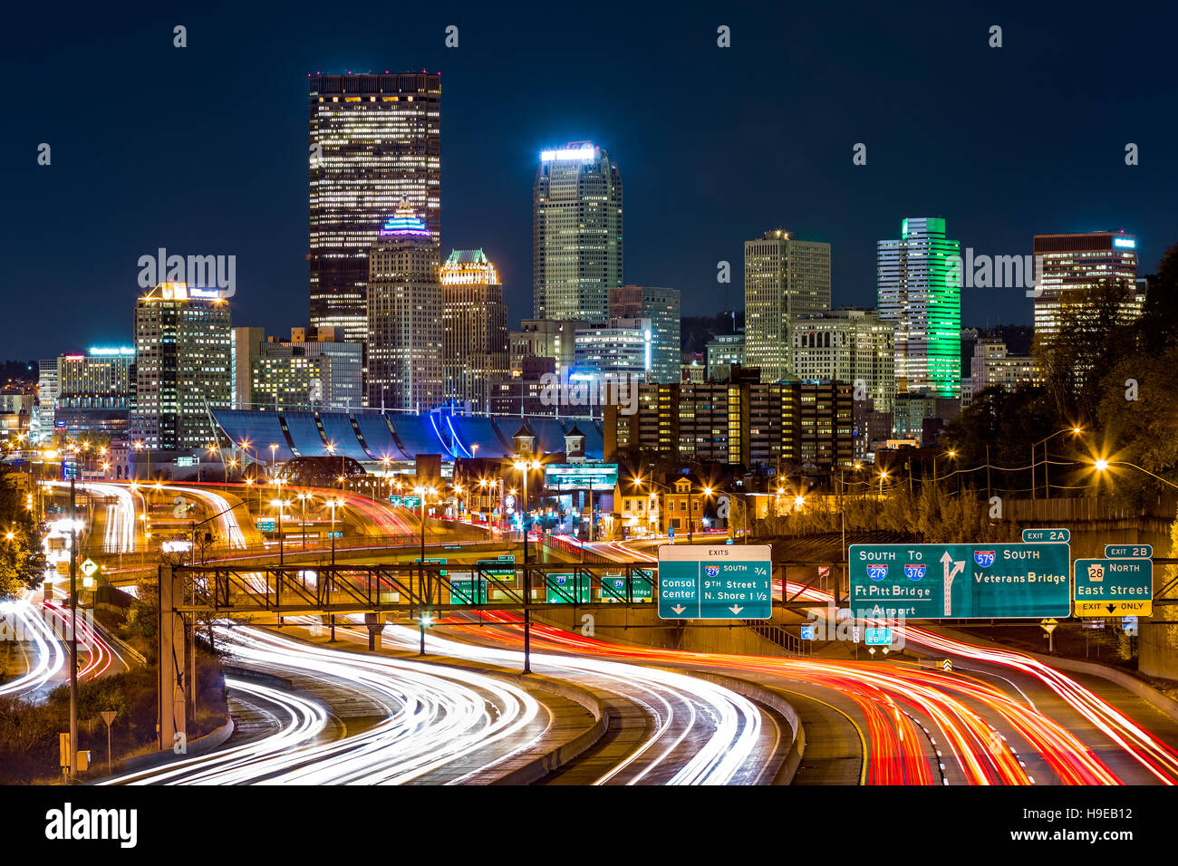 Pittsburgh skyline by night. The rush hour traffic leaves light trails on I-279 parkway Stock Photo