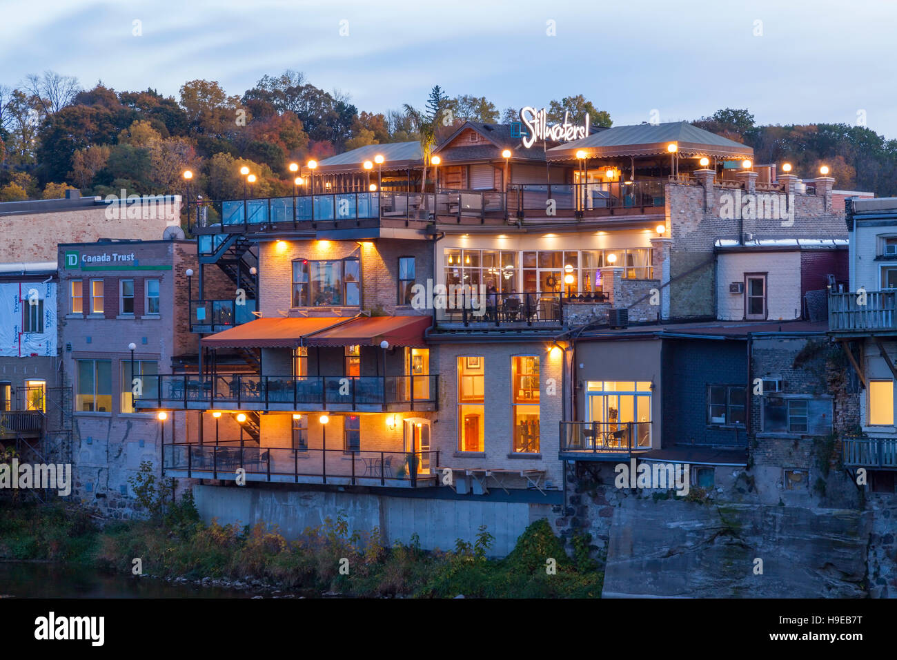 The back of buildings that run along Grand River Street at dusk in