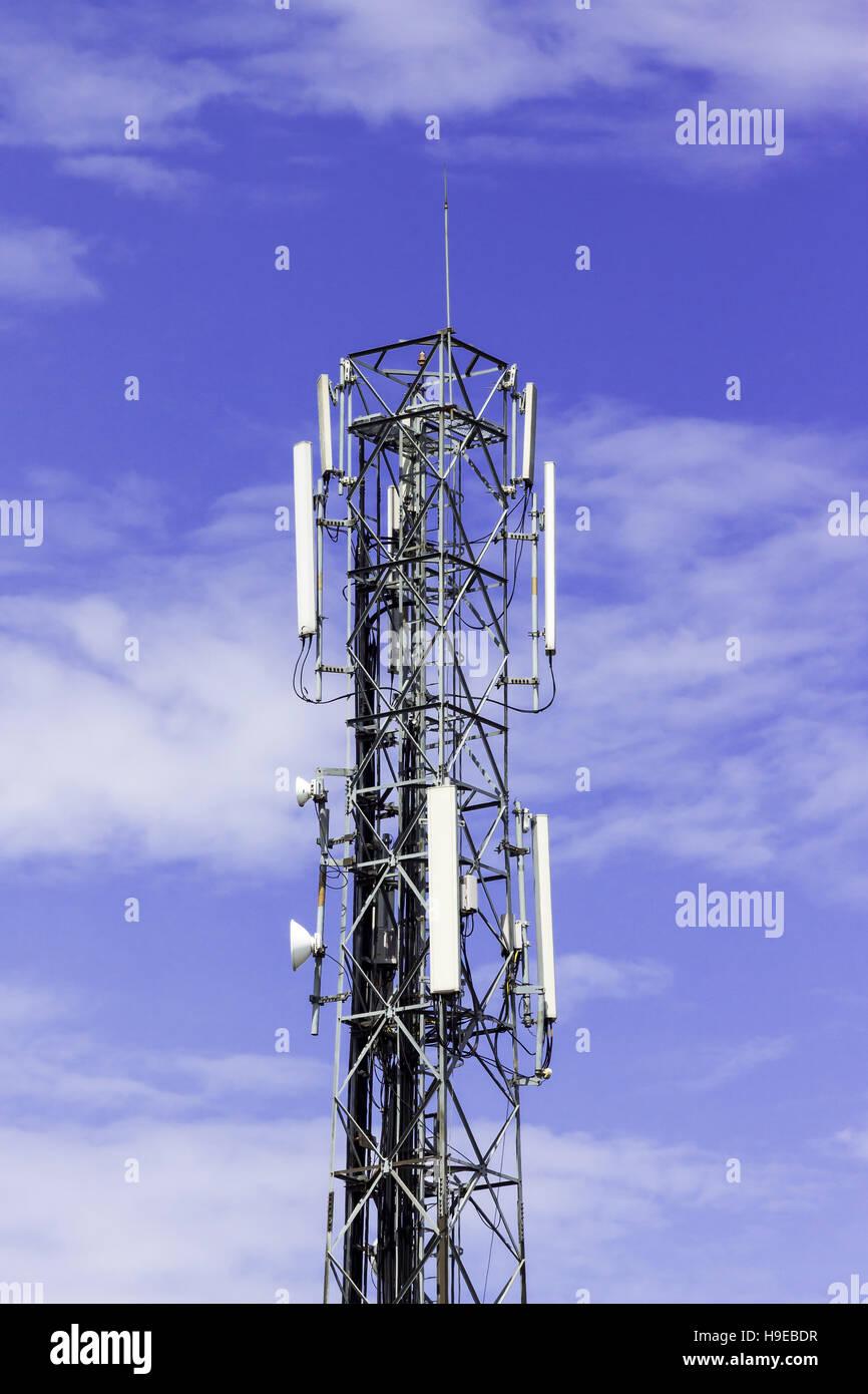 Radio telecommunication infrastructure tower against beautiful blue sky on background. Stock Photo