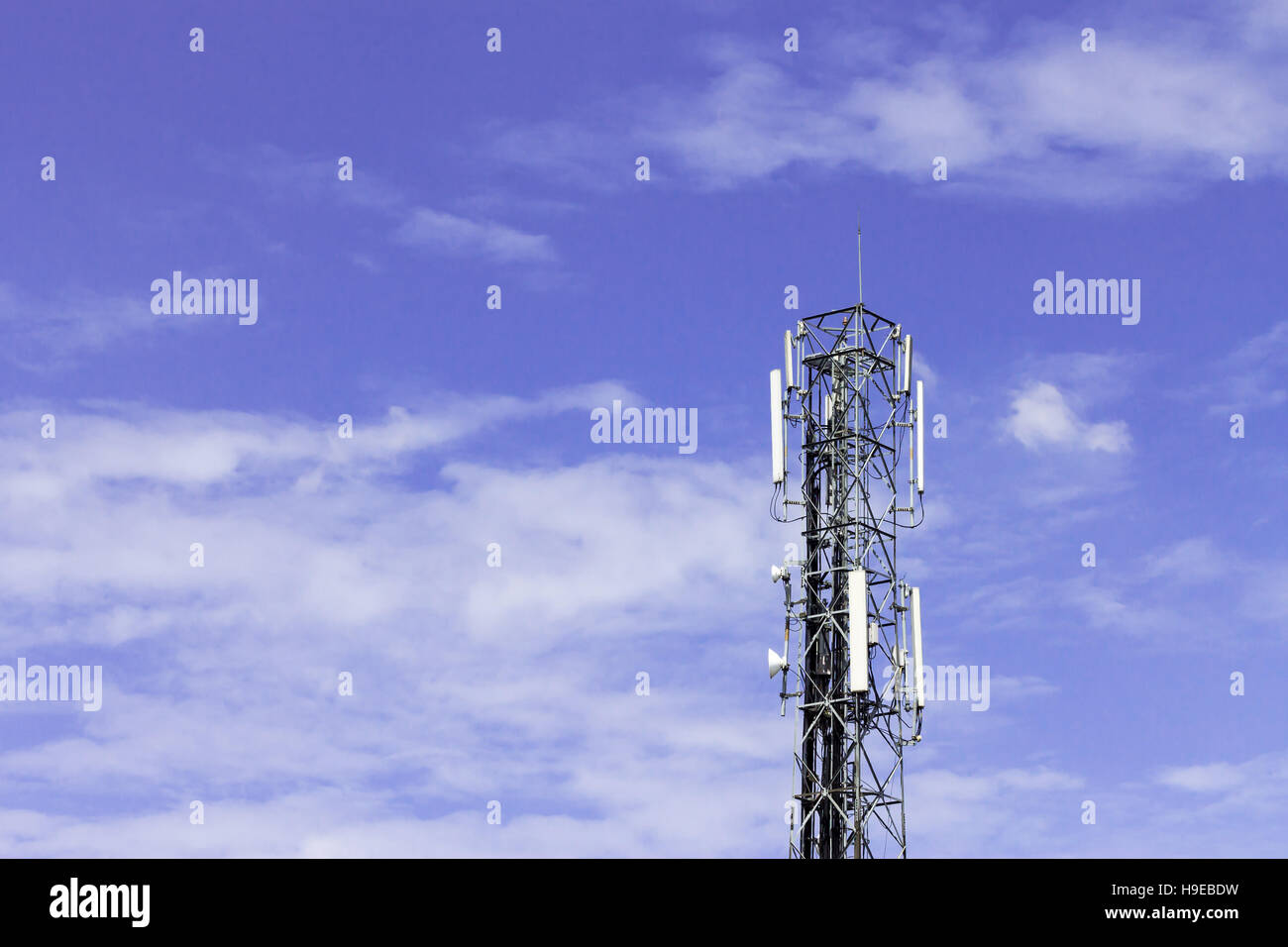 Radio telecommunication infrastructure tower against beautiful blue sky on background. Stock Photo