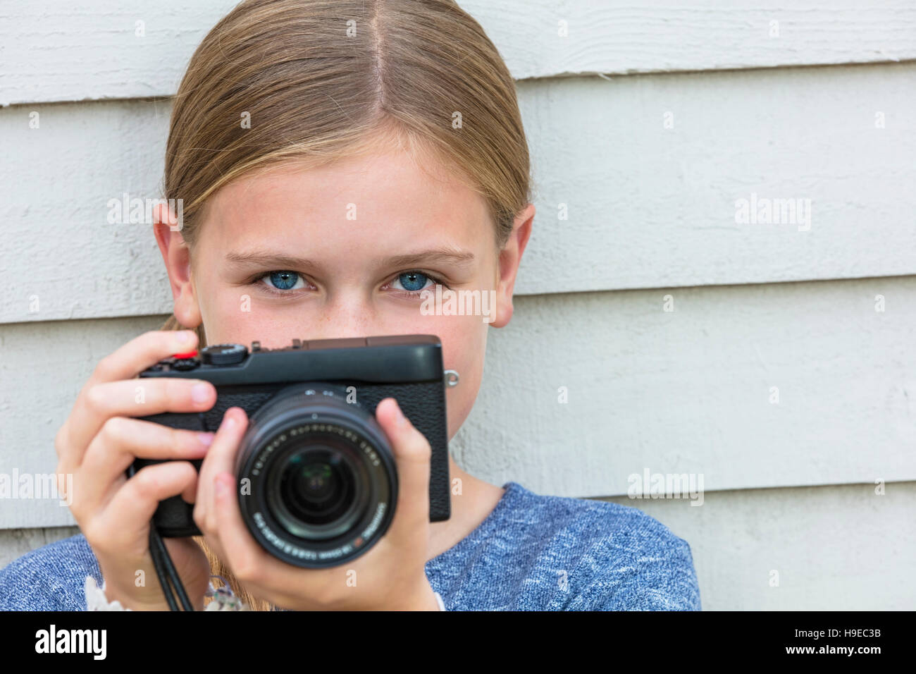 Girl child taking picture with a digital camera Stock Photo