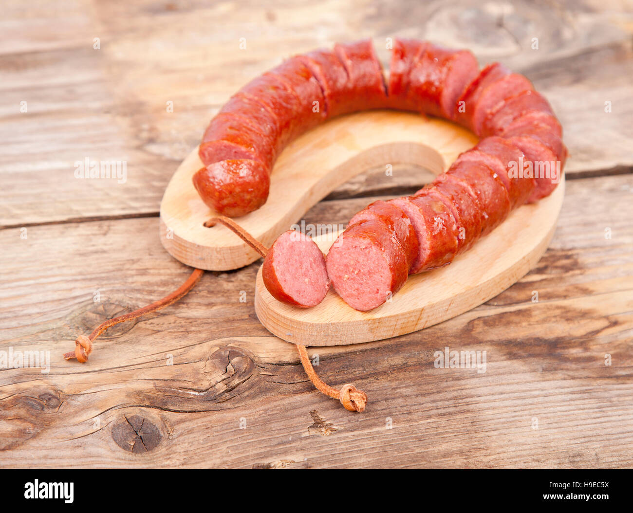 Traditional Dutch smoked sausage called Rookworst on wooden background Stock Photo
