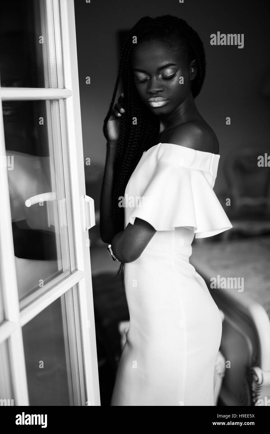 black and white photo of african woman. Girl in white dress with white  makeup and closed eyes Stock Photo - Alamy