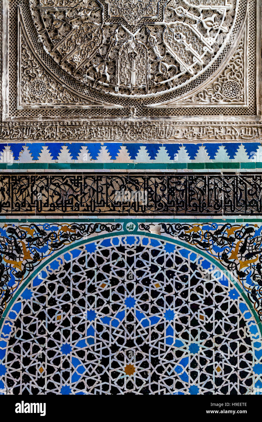 Arabic Calligraphy and Mosaic Tiles At The Medersa El-Attarine, Fez el Bali, Fez, Morocco Stock Photo