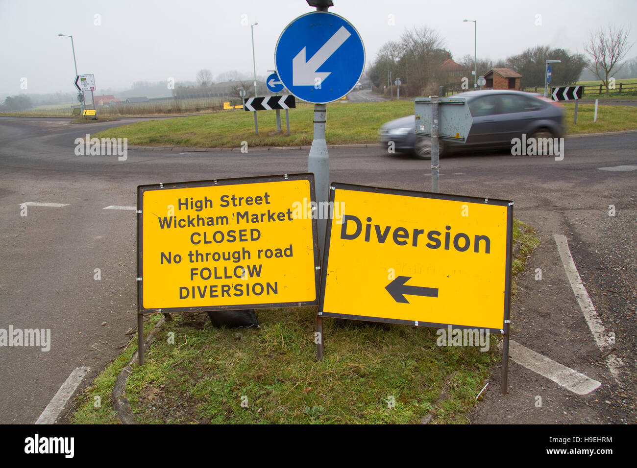 Multiple temporary road signs on a roundabout near Wickham Market Suffolk Stock Photo