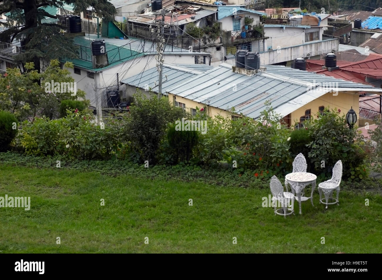 Nainital - view of rooftops, lawn and wrought iron chairs. Uttaranchal, India. Stock Photo