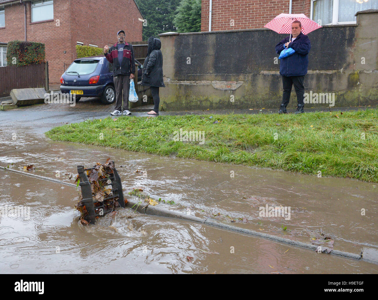 Residents look at a blocked drain as the clean up begins in Whitchurch ...