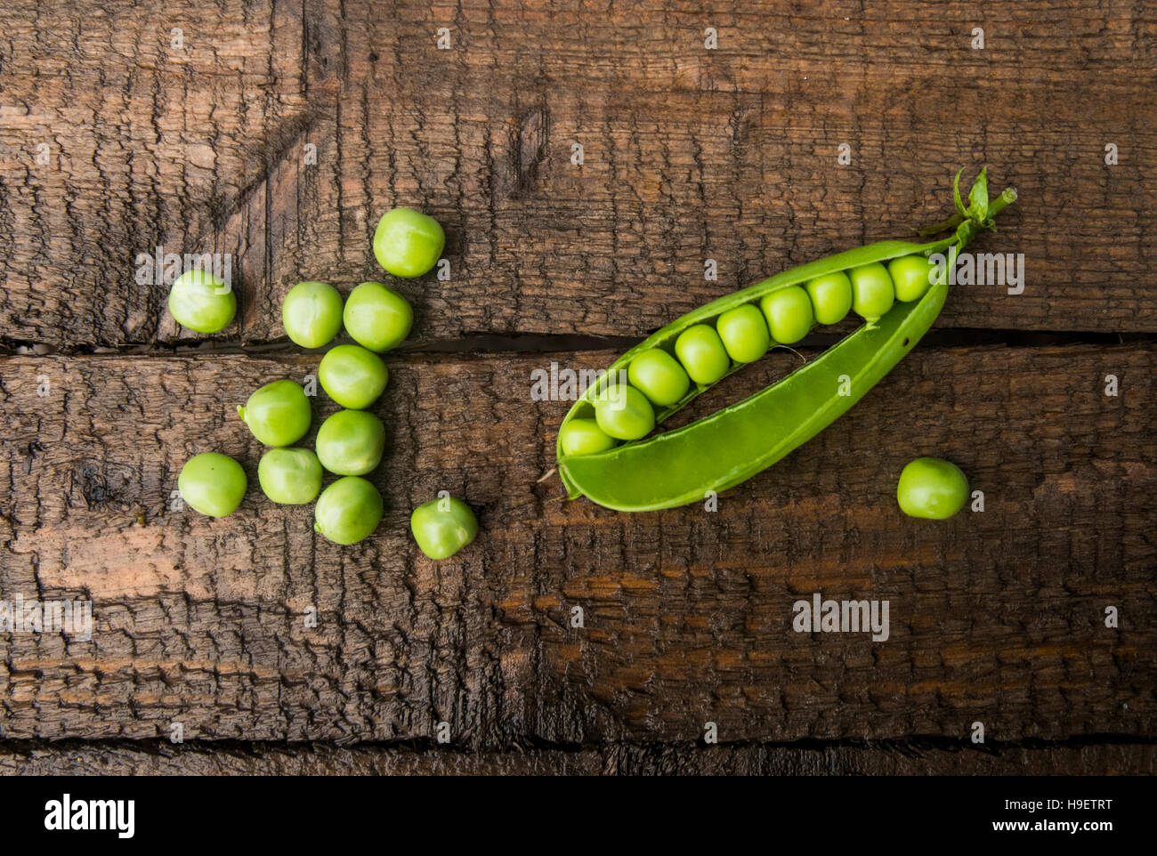 Fresh peas on wooden table Stock Photo